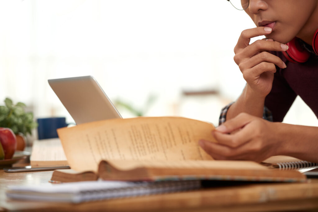 Close-up image of student reading important information in a book